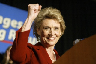 Gov. Christine Gregoire raises her hand in triumph as she peaks to a crowd at the Democratic Party election night party at Westin Hotel in Seattle Tuesday.