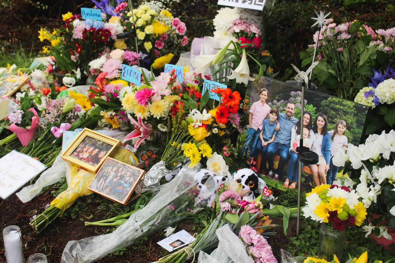 Flowers, framed photos, plush toys and a QR code to the GoFundMe pages of the families grace the memorial site after the March 19 crash. Photo by Bailey Jo Josie/Alb Media.
