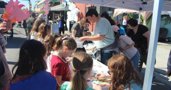 Kids making dragon arts and crafts at the Erasmus hatching party street fair. Photo by Bailey Jo Josie/Alb Media.