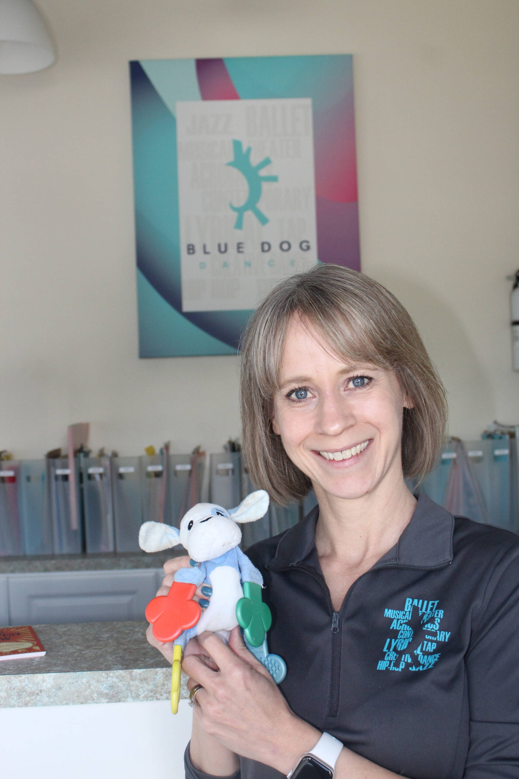 Blue Dog Dance founder Barbara Walshe holds her daughters’ toy that inspired the name of her dance studio. Photo by Bailey Jo Josie/Alb Media.