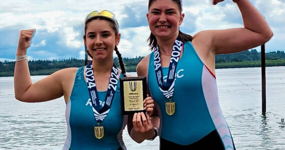 Lily Pahl (left) and Tabitha Pahl posing with their medals and plaque after their rowing win. Photo courtesy of Lesley Pahl