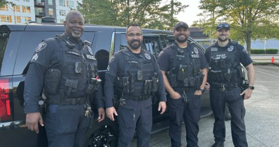 Renton Police Department officers Sgt C. Jacobs, Sgt. C. Johnson, Traffic Officer C. Catalan, and Traffic Officer M. Nugent in front of a police vehicle. Photo courtesy of Ryan Rutledge