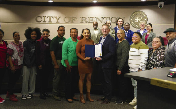 Danielle Smith, others, and the Renton City Council posing for a photo with the Juneteenth proclamation. Photo courtesy of the City of Renton